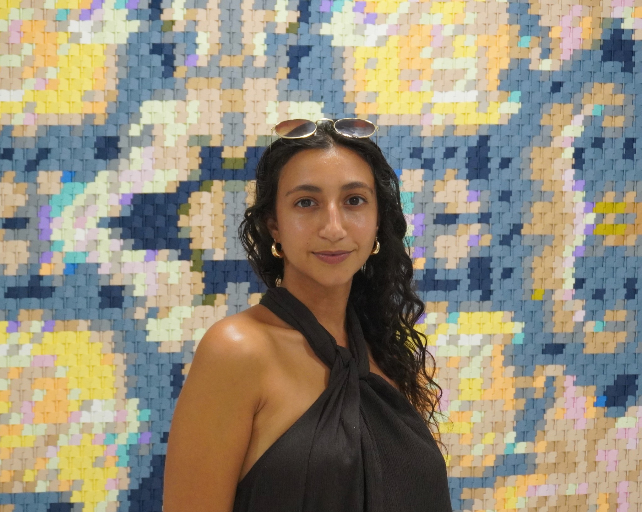 Jess Mouawad in front of a colorful artwork